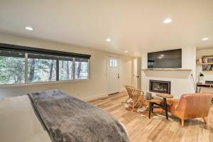 a living room with a bed and a fireplace at Renovated Riverfront Missoula Home with Deck! in Missoula