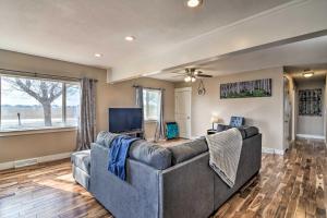 a living room with a couch and a tv at Cozy Retreat with Yard Space about 11 Mi to Longmont! in Platteville