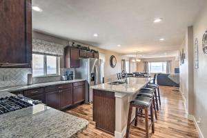 a kitchen with a counter and chairs in a room at Cozy Retreat with Yard Space about 11 Mi to Longmont! in Platteville