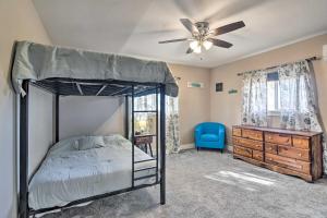 a bedroom with a bed and a ceiling fan at Cozy Retreat with Yard Space about 11 Mi to Longmont! in Platteville