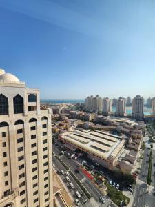 an aerial view of a city with tall buildings at Luxurious 2-bedroom Apartment with Sea View in Doha