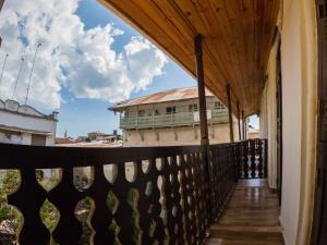 a balcony with a wooden fence and a building at Aurelia Zanzibar in Ngambo