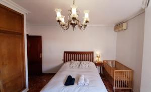 a bedroom with a bed with two pairs of shoes on it at Apartamento Murcia a tus pies in La Alberca