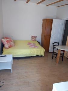 a small bedroom with a yellow bed and a table at Studio apartment in Ika with balcony, air conditioning, WiFi, washing machine 5025-3 in Ika