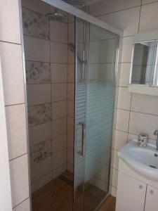 a shower with a glass door next to a sink at Studio apartment in Ika with balcony, air conditioning, WiFi, washing machine 5025-3 in Ika