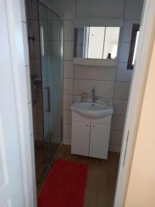 a bathroom with a sink and a glass shower at Studio apartment in Ika with balcony, air conditioning, WiFi, washing machine 5025-3 in Ika