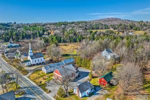 an aerial view of a small town with houses and trees at Charming Farmhouse Walk to Village and Trails! in East Burke