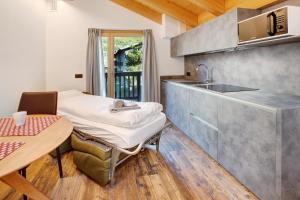 a small kitchen with a table and a sink at Olympic Chalet 12 in Bormio