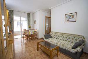 a living room with a couch and a table at Alegria ID40 in Torrevieja