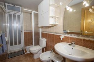 a bathroom with a sink and a toilet and a mirror at Alegria ID40 in Torrevieja +24 photos
