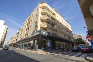 a building on a street with cars parked on the street at Alegria ID40 in Torrevieja