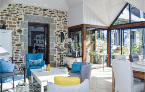 a living room with a stone wall at Awesome Home In Trézélanbégard in Trézelan