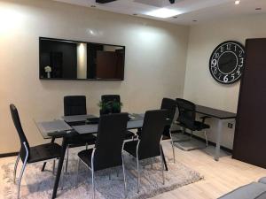 a dining room with a table and black chairs at Well located apartment in Casablanca- 12 MO internet- Netflix in Casablanca