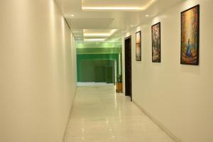 a corridor of an office with paintings on the walls at Hotel Lawrence in Amritsar