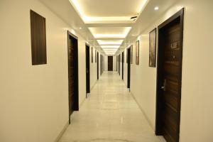 a corridor in a building with a long hallway at Hotel Lawrence in Amritsar