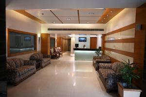 a lobby with couches and a bar in a hospital at Hotel Lawrence in Amritsar