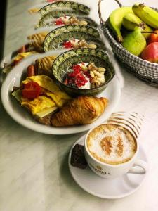 a table with plates of food and a cup of coffee at Boutique Hotel Skamnos Arachova in Arachova