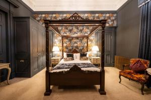een slaapkamer met een hemelbed en een baldakijn bij No11 Boutique Hotel & Brasserie in Edinburgh