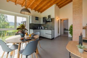 a kitchen and dining room with a table and chairs at Corte Odorico in Pedemonte