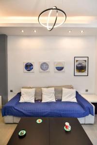 a bedroom with a large bed with a blue blanket at Excellent apartment luxuriously renovated in Larisa