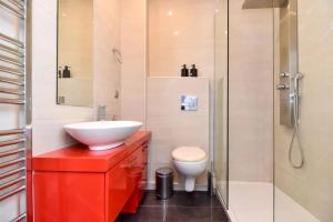 a bathroom with a sink and a toilet and a shower at Excellent apartment luxuriously renovated in Larisa