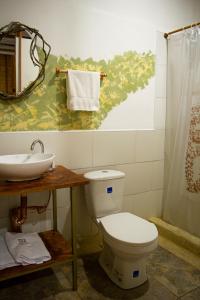 a bathroom with a toilet and a sink at Refugio del Jaguar in Medellín
