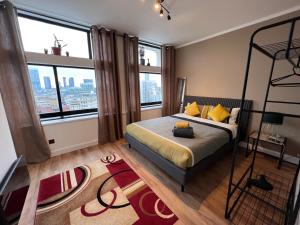 a bedroom with a bed and large windows at City View 2 Bedrooms Flat in Manchester
