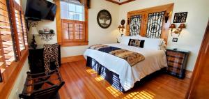 a bedroom with a bed and a flat screen tv at Pettigru Place Bed & Breakfast in Greenville