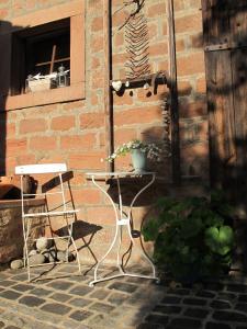 a patio with two chairs and a table and a window at Ferienwohnung-Spessart in Straßbessenbach