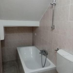 a bathroom with a white tub and a toilet at La Finestra Verde in Montignoso