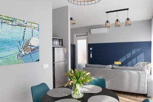 a living room with a couch and a table at Aranygesztenye Apartmanház in Balatonudvari