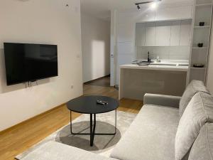 a living room with a couch and a table at Apartman 306 in Lukavica