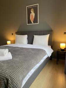a bedroom with a large bed with two lamps on it at Zen Sea in Alexandroupoli