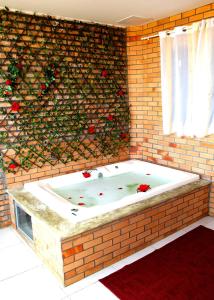 a jacuzzi tub in a brick wall at Hotel Costa Atlantico in Areia Branca