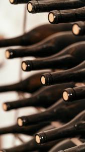 a row of black wine bottles are lined up at Puleera Boutique Hotel in San Leonardello
