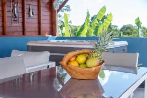 a basket of fruit sitting on a table at Les Hauts de Sainte-Anne "2 Spas privatifs" in Sainte-Anne