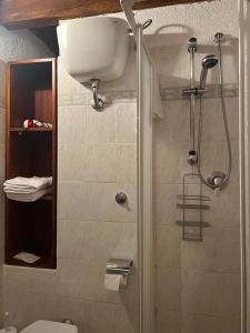 a bathroom with a shower with a toilet and a sink at Residenza San Jacopo in Spello