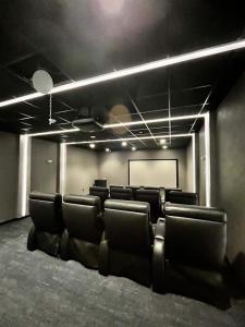 a conference room with chairs and a projection screen at Queen of Charm Luxury Suite Downtown Hartford Location!Location!Location! in Hartford