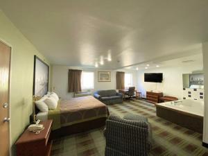 a hotel room with a bed and a bath tub at Super 8 by Wyndham Pittsburgh/Monroeville in Monroeville