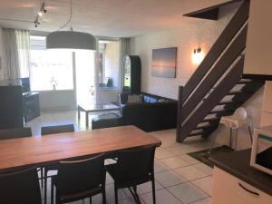 a kitchen and living room with a table and a living room at Bruinisse-Zeeland-Holland in Bruinisse +22 photos