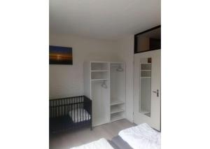 a white room with a bed and a closet at Bruinisse-Zeeland-Holland in Bruinisse