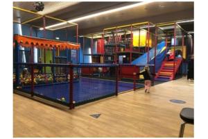a young girl standing in a play room with a tennis court at Bruinisse-Zeeland-Holland in Bruinisse