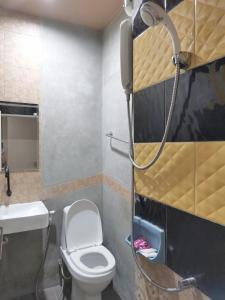 a bathroom with a toilet and a shower at Hive in Bang Kapi