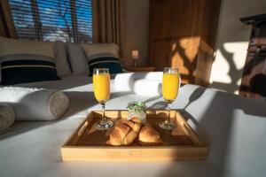 a tray of bread and two glasses of orange juice at Milverton Hotel in Manchester