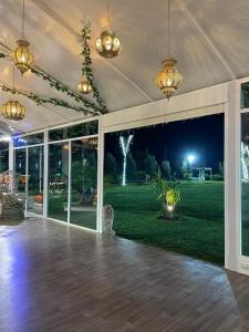 an empty room with a wooden floor and lights at Jnane Nina in Tagadirt