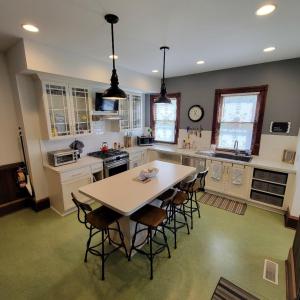 a large kitchen with a table and chairs in it at Art and Lodging in South Bend