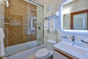 a bathroom with a toilet and a shower and a sink at Mount Healthy Villas 6- bedrooms with spa & pool in Tortola Island
