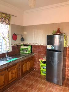 a kitchen with a black refrigerator and a sink at Sidi bouzid in Douar Zeraoula