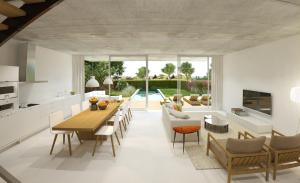 a kitchen and living room with a table and chairs at Villa Barcares in Alcudia