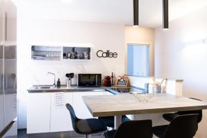 una cucina con tavolo e sedie di Clover - 13 Piazza Pio XI a Roma